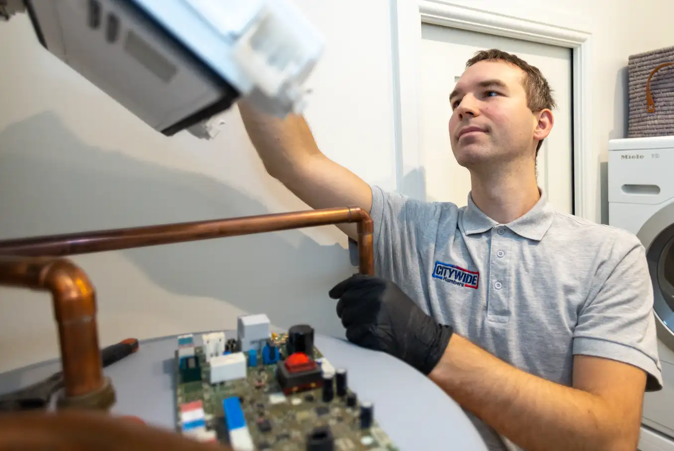 Citywide Plumbers engineer checking a boiler system