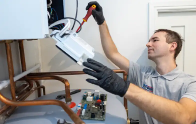 Engineer servicing a boiler